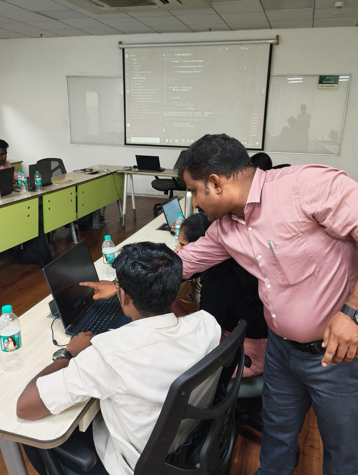 A mentor guiding a student through the build during the workshop